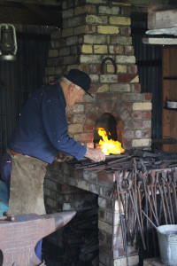 Society member volunteer Malcolm Paine working the Blacksmith Forge